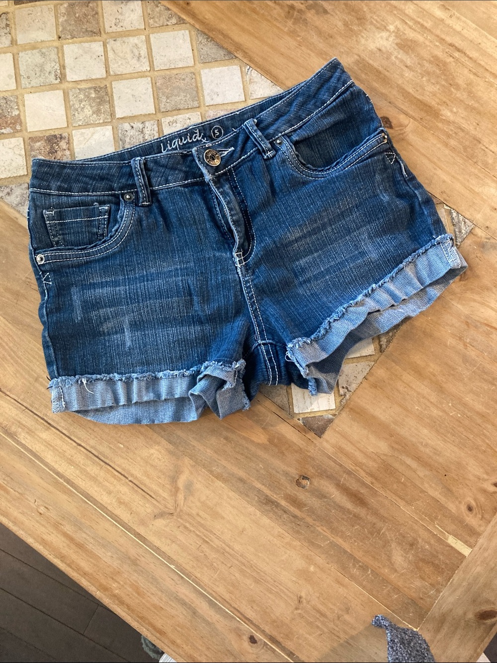 Liquid Blue Frayed Ruffle Hem Denim Shorts in Blue